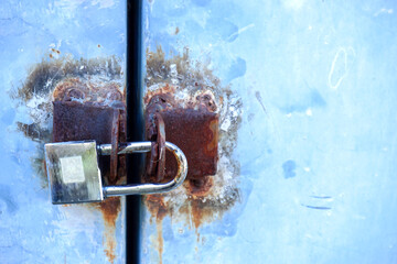 Rosty blue lock on blue door