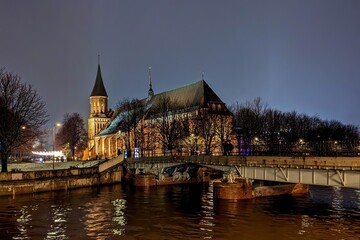 Kaliningrad, Russia - December 22, 2023: Honey Bridge, Cathedral, Kant Island (Kneiphof). Evening in Kaliningrad.