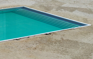 Summer Season Begins. Clean Pool Water and Dirty Stone Floor.