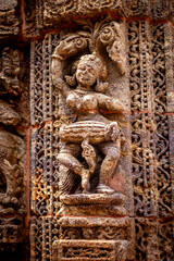 A dancer playing a drum Carvings of musicians and dancers that almost completely cover the platform, walls and pillars of the hall on Bhoga Mandapa or the dance hall, Sun Temple, Konark, India.