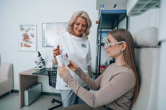 Smiling doctor examining patient's vision with eye chart at clinic