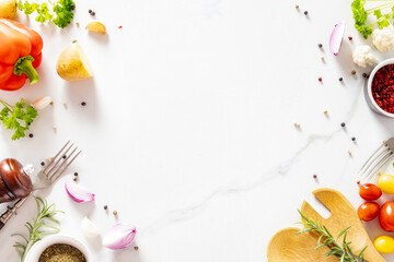 A flat lay of various fresh ingredients for cooking healthy food including vegetables, spices, and herbs on a white marble background with copy space top view, perfect for culinary concepts