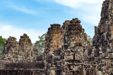 Fototapeta premium The bayon temple smiling stone faces showing on a sunny day in angkor thom, siem reap, cambodia