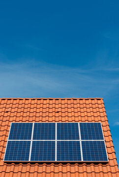 Solar panels installed on roof under blue sky