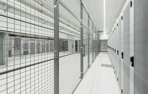 Illuminated server room with fence at data center