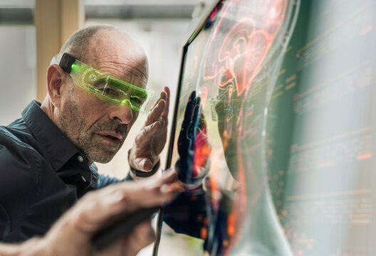 Focused doctor analyzing human brain function with help of AI technology eyeglasses