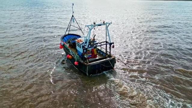 Fishing Boat, trawler, just offshore fishing, trawling with the coast, coastline visible