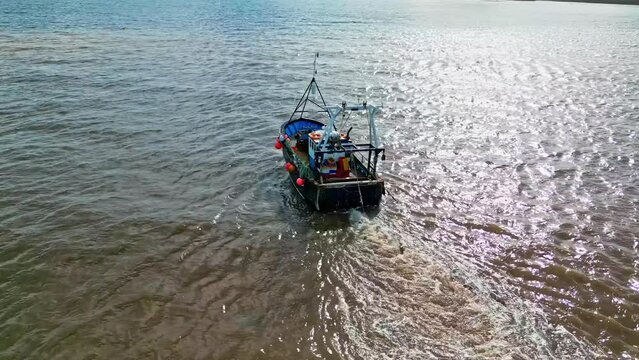 Fishing Boat, trawler, just offshore fishing, trawling with the coast, coastline visible