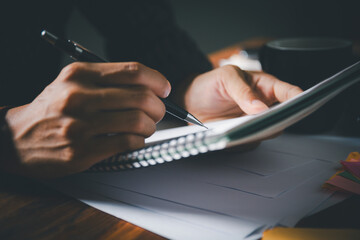 Student is diligently writing in notebook during  tutoring session, preparing for exams. education...