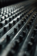 A detailed view of a mixing board with various knobs and controls