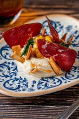 Hummus with pastrami, traditional Turkish dish, on wooden table