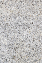A close up image displaying a textured gray granite surface