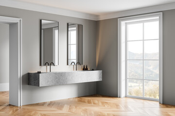 Hotel bathroom interior with double sink and panoramic window, accessories