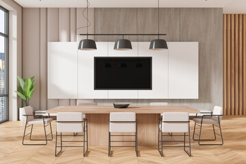 Modern home kitchen interior with dining table and tv screen, panoramic window