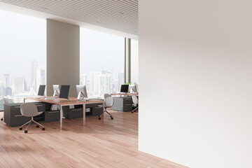 Office workplace interior with desks and pc computers near window. Mockup wall