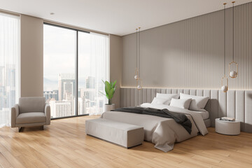Modern hotel bedroom interior with bed, bench and armchair near panoramic window