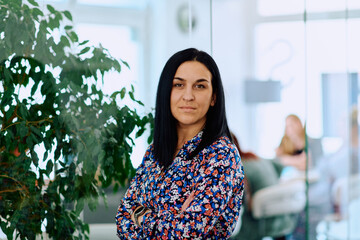 Portrait of a Confident Businesswoman with Crossed Arms in Her Office Environment.