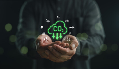 Businessman hands showing with carbon reduction for decrease CO2, carbon footprint and carbon credit to limit global warming from climate change, Bio Circular Green Economy concept.