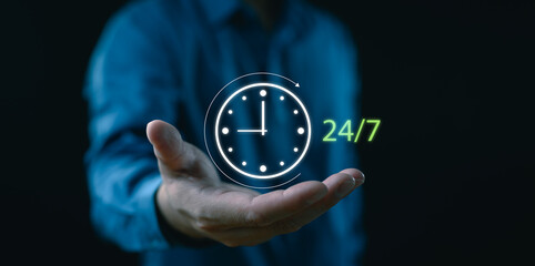 Nonstop service concept. Businessman hand holding virtual 24-7 with clock on hand for worldwide...