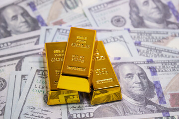 Gold bar on US dollar banknotes money , Economy finance exchange trade investment concept.