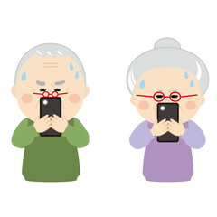 眼鏡をかけて目を凝らしスマホを見るシニア