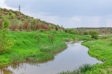 Scenic river flowing through lush green field. Winding river and countryside landscape