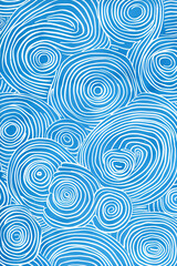 Fototapeta premium Abstract pattern of blue and white swirled lines creating circular shapes