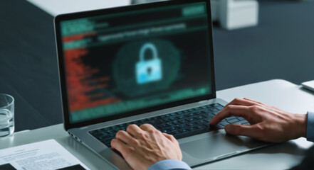 Person typing on a laptop with holographic warning symbols on the screen in an office environment, bypass protection, softly blurred concept of cybersecurity threat.