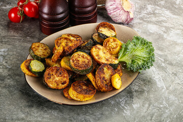 Roasted young zucchini in the plate
