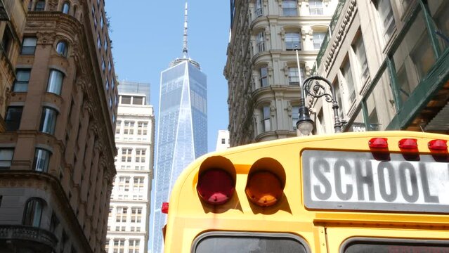 Yellow School Bus. Schoolbus back view on Fulton street, New York City Manhattan Downtown. Children education and transportation, USA. American school shuttle, World Trade Center tower, United States.