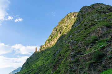 Signal tower on the edge of a cliff near the medieval village of Mutso. Blue sky with clouds