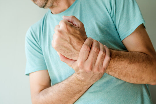 Severe wrist pain symptoms, man with painful medical condition