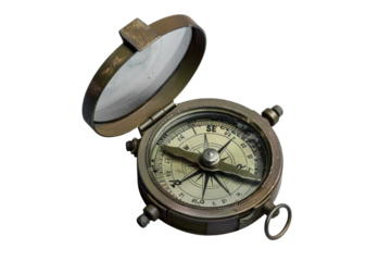 Vintage brass compass with open lid, showcasing detailed navigational markings and direction needle, ideal for exploration and adventure themes.