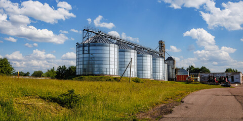 Obraz premium silos on agro-industrial complex with seed cleaning and drying line for grain storage