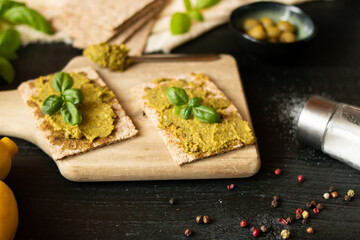 Fresh pesto sauce. on a dark background. ingredients