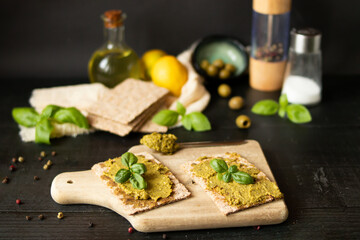 Fresh pesto sauce. on a dark background. ingredients