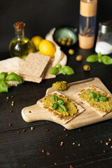 Fresh pesto sauce. on a dark background. ingredients