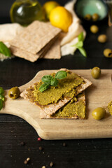 Fresh pesto sauce. on a dark background. ingredients