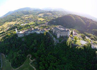 Aerial view of the small village of Compiano and the castle of Compiano. Compiano, Parma, Italy