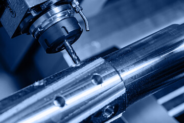 CNC turning production of shafts for cars factory. Concept machine for cut metal industry, blue color background