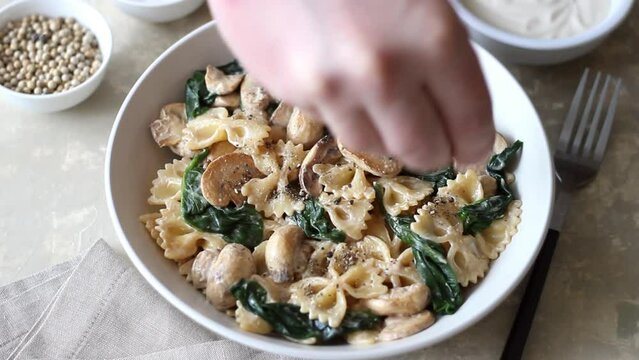 Farfalle pasta with mushrooms and spinach. Healthy eating. Vegetarian food.
