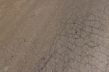 a part of a highway covered with cracked asphalt