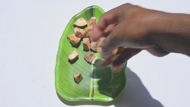 Chopped raw jackfruit. Unripe jackfruit has been cut into small, bite sized pieces. When the fruit is young and unripe, it has a firm, texture and a neutral taste. Its vegetable or pickle can be made.