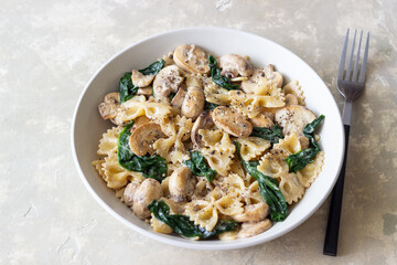 Farfalle pasta with mushrooms and spinach. Healthy eating. Vegetarian food.