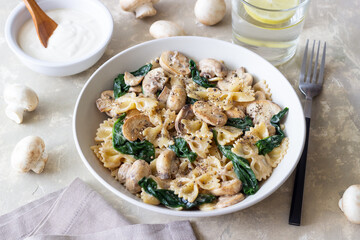 Farfalle pasta with mushrooms and spinach. Healthy eating. Vegetarian food.