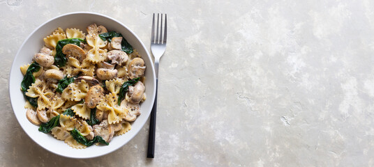 Farfalle pasta with mushrooms and spinach. Healthy eating. Vegetarian food.