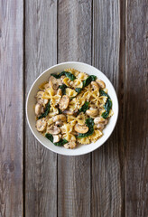 Farfalle pasta with mushrooms and spinach. Healthy eating. Vegetarian food.