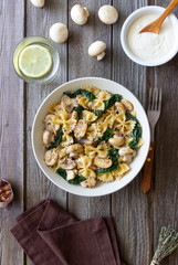 Farfalle pasta with mushrooms and spinach. Healthy eating. Vegetarian food.