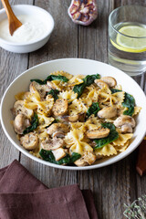 Farfalle pasta with mushrooms and spinach. Healthy eating. Vegetarian food.