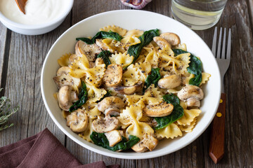 Farfalle pasta with mushrooms and spinach. Healthy eating. Vegetarian food.